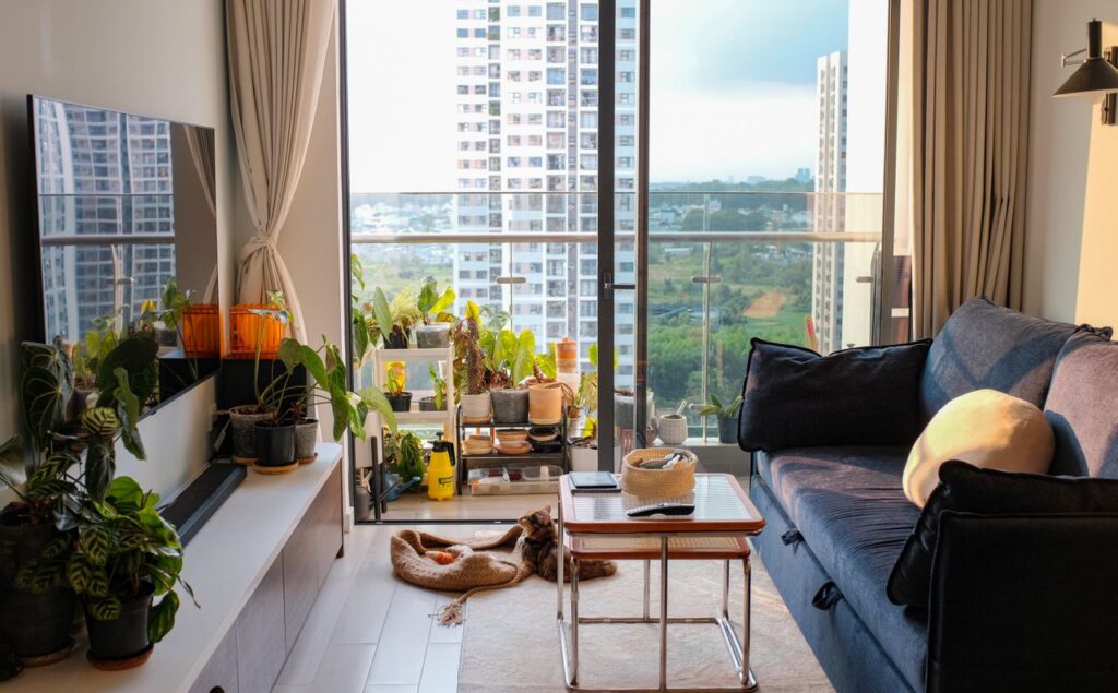 Bright and cozy living room featuring a balcony garden with city views.