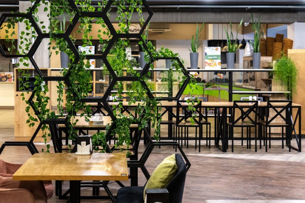 Stylish food court in Yerevan with modern design and greenery accents.
